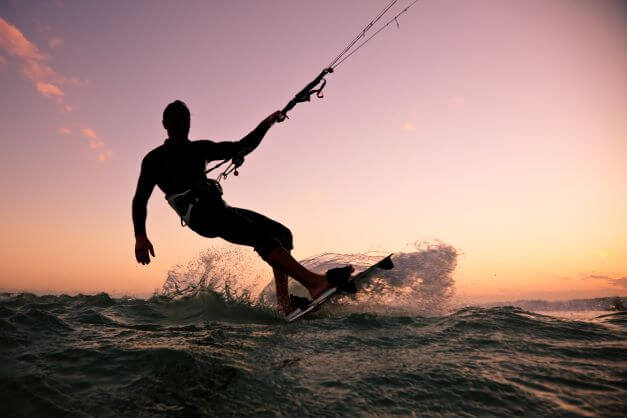Kite surfing into a sunset