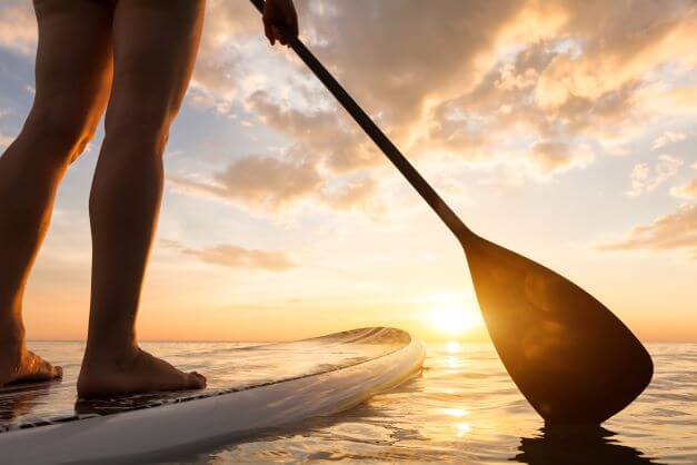 Paddle boarding into the sunset